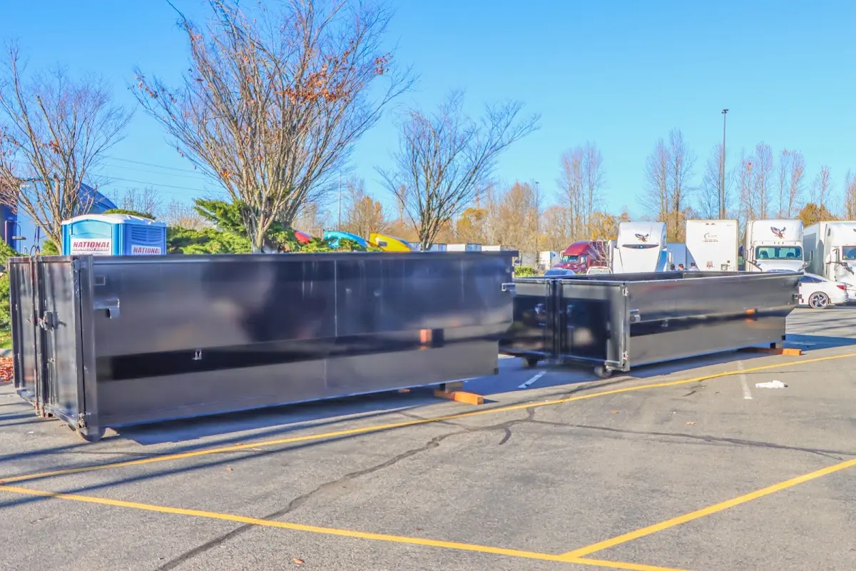 Professional dumpster rental service with roll-off container on residential driveway in Jan Phyl Village